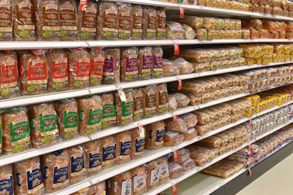 Packages of sliced breads on a grocery store shelf. Photo: Shutterstock